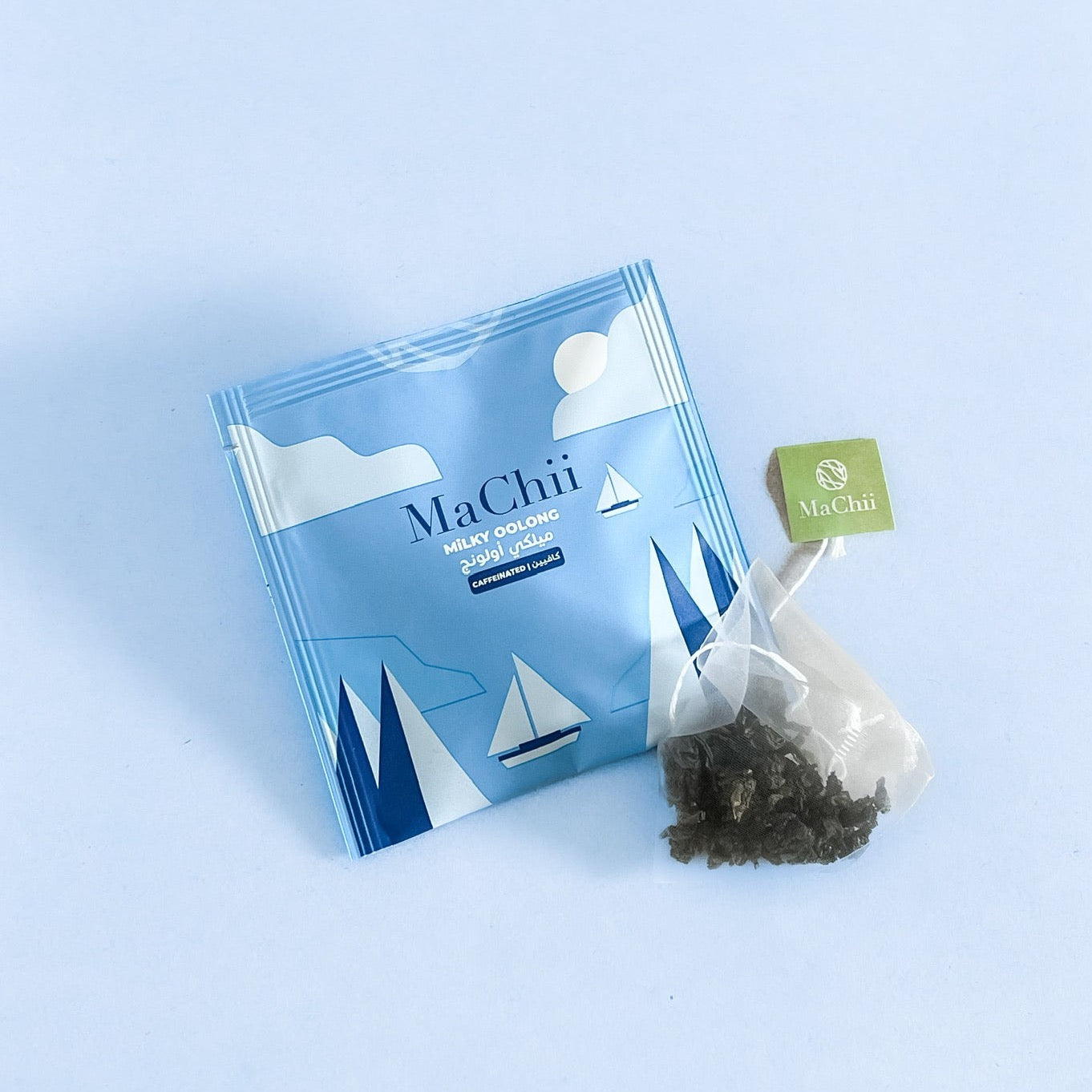 Milk oolong biodegradable Chinese Milk Oolong silk tea bag on an envelope. On a blue backrgound