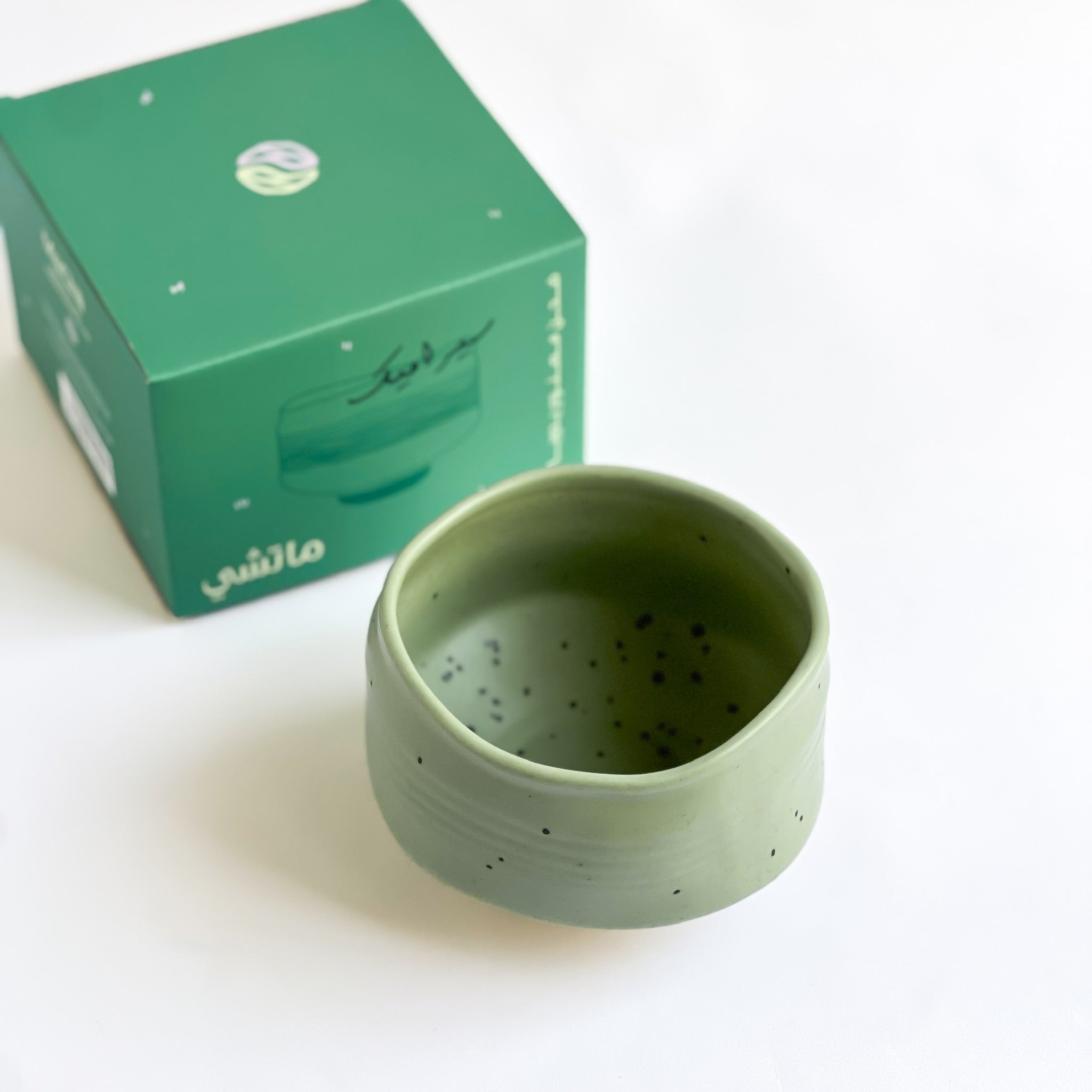 handmade green matcha bowl next to MaChii Tea box