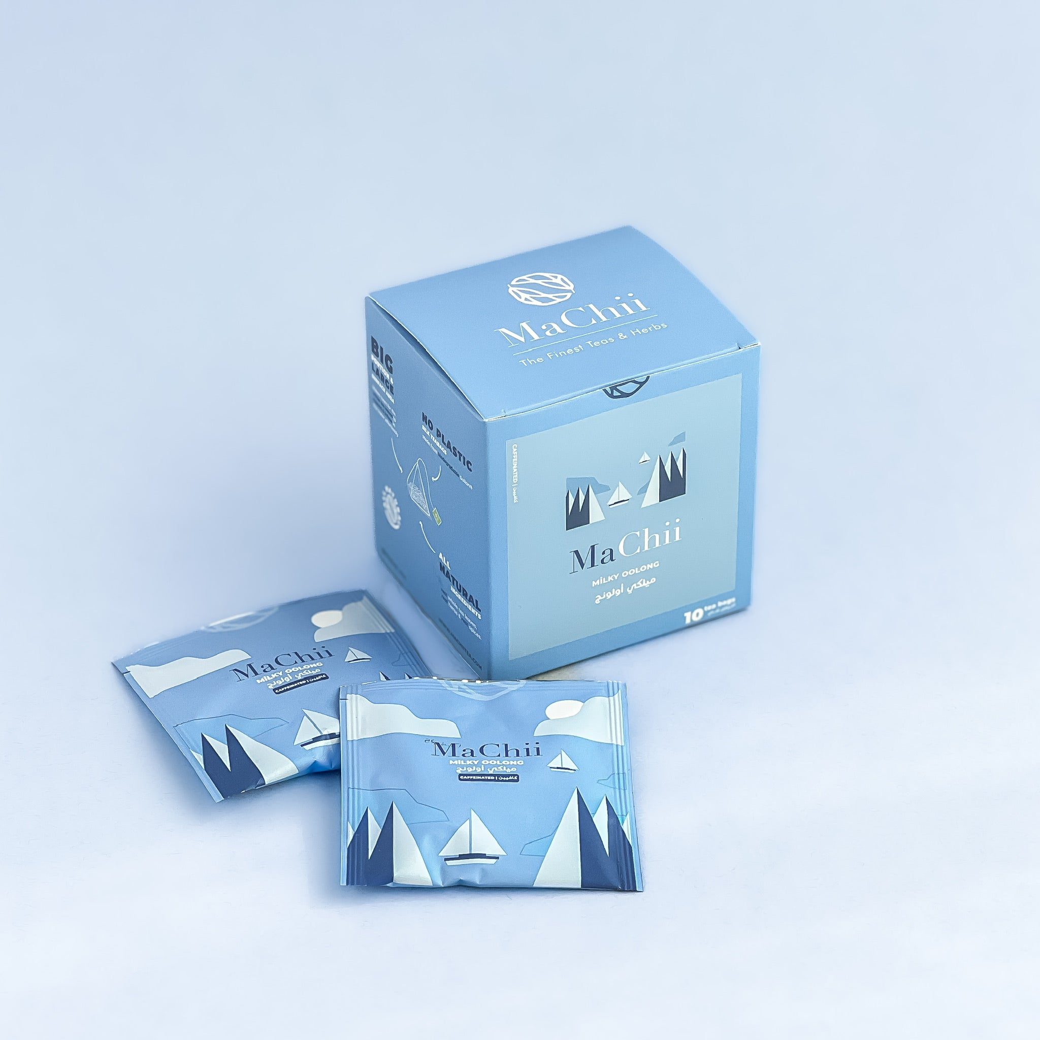 organic milky oolong tea envelopes next to a blue tea packaging