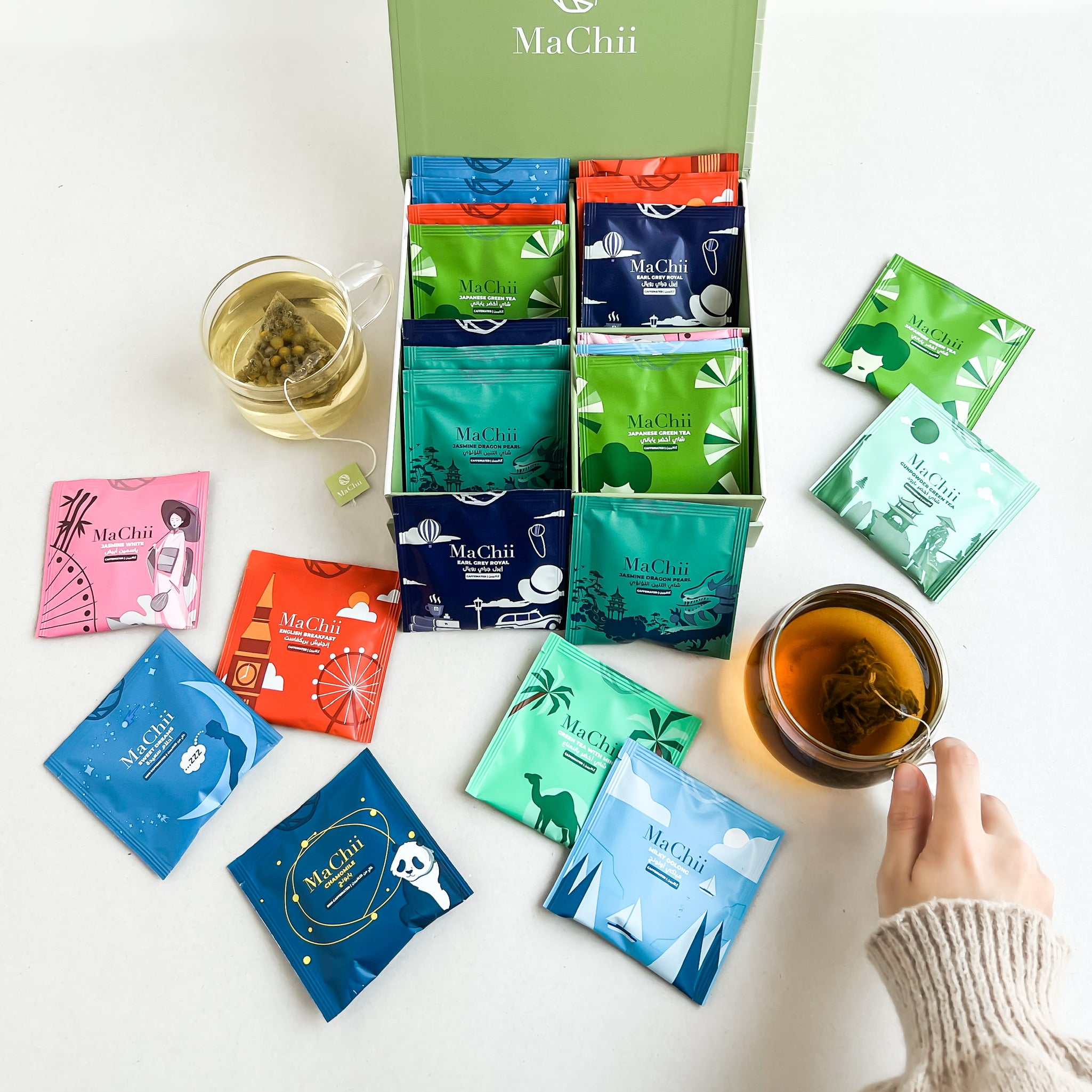 tea blends next to a brewed cup of tea. green tea, black tea, herbal tea, oolong tea, smoky tea. 