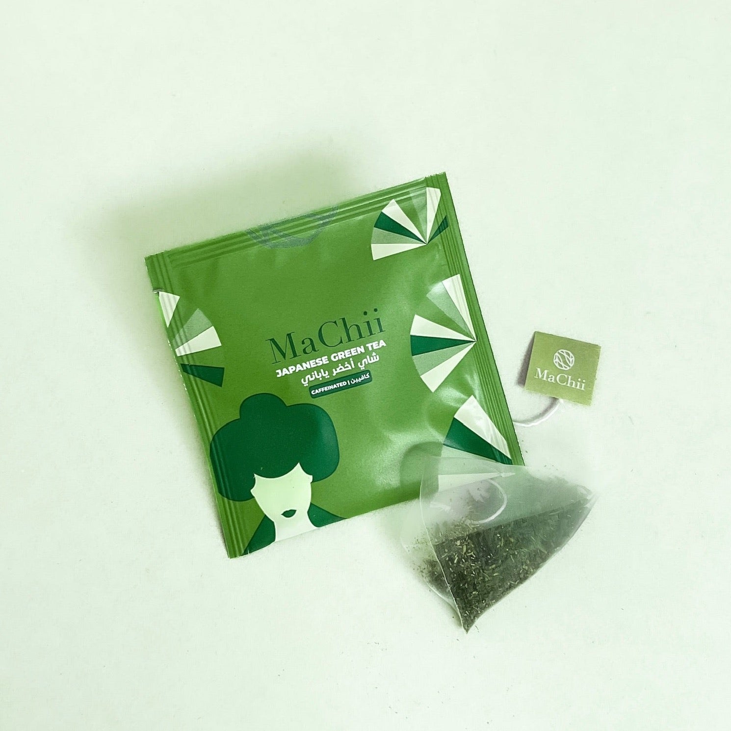 Japanese sencha green tea in a silk tea bag on an envelope 