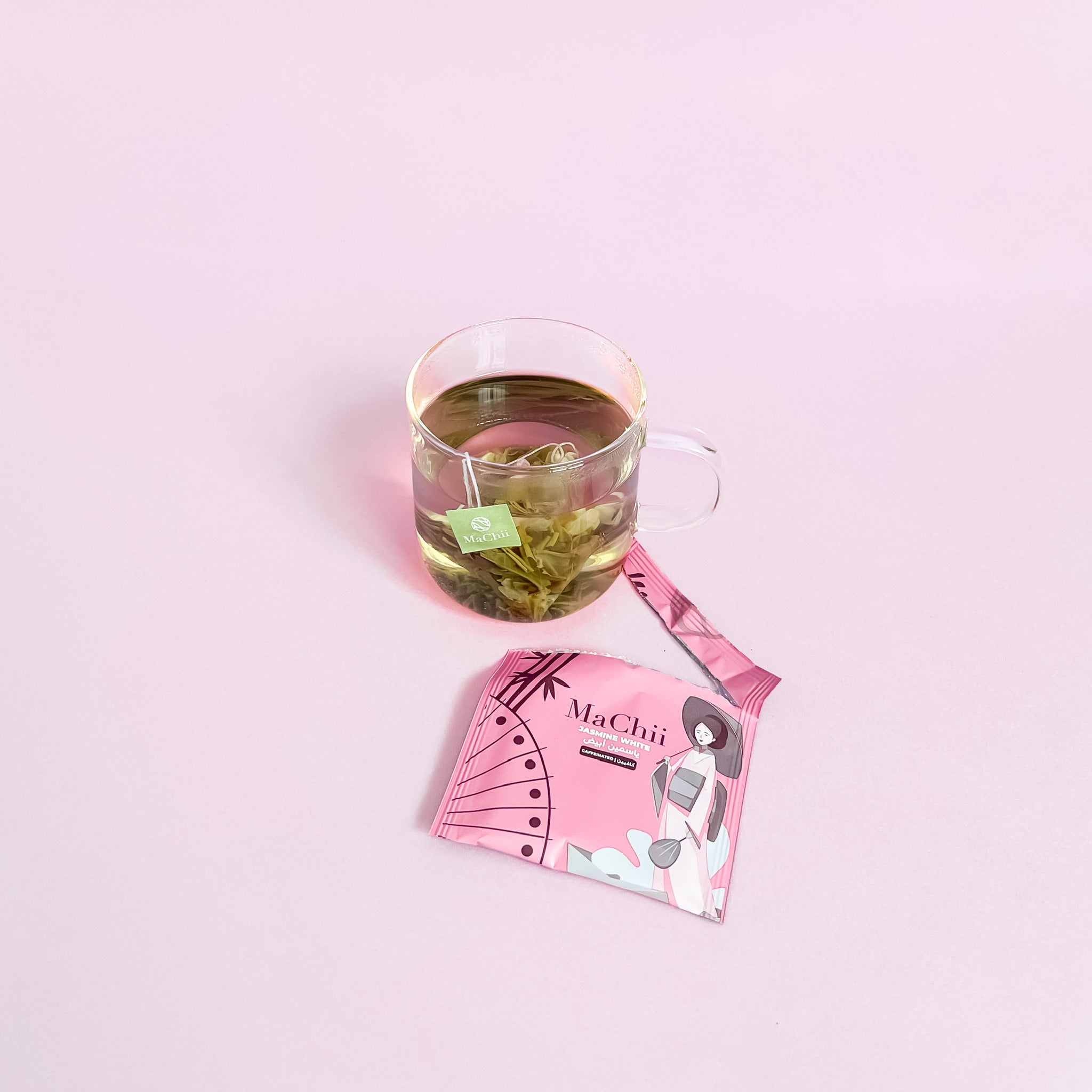 wholesale tea jasmine white tea bag in tea cup brewing. envelope open to the side