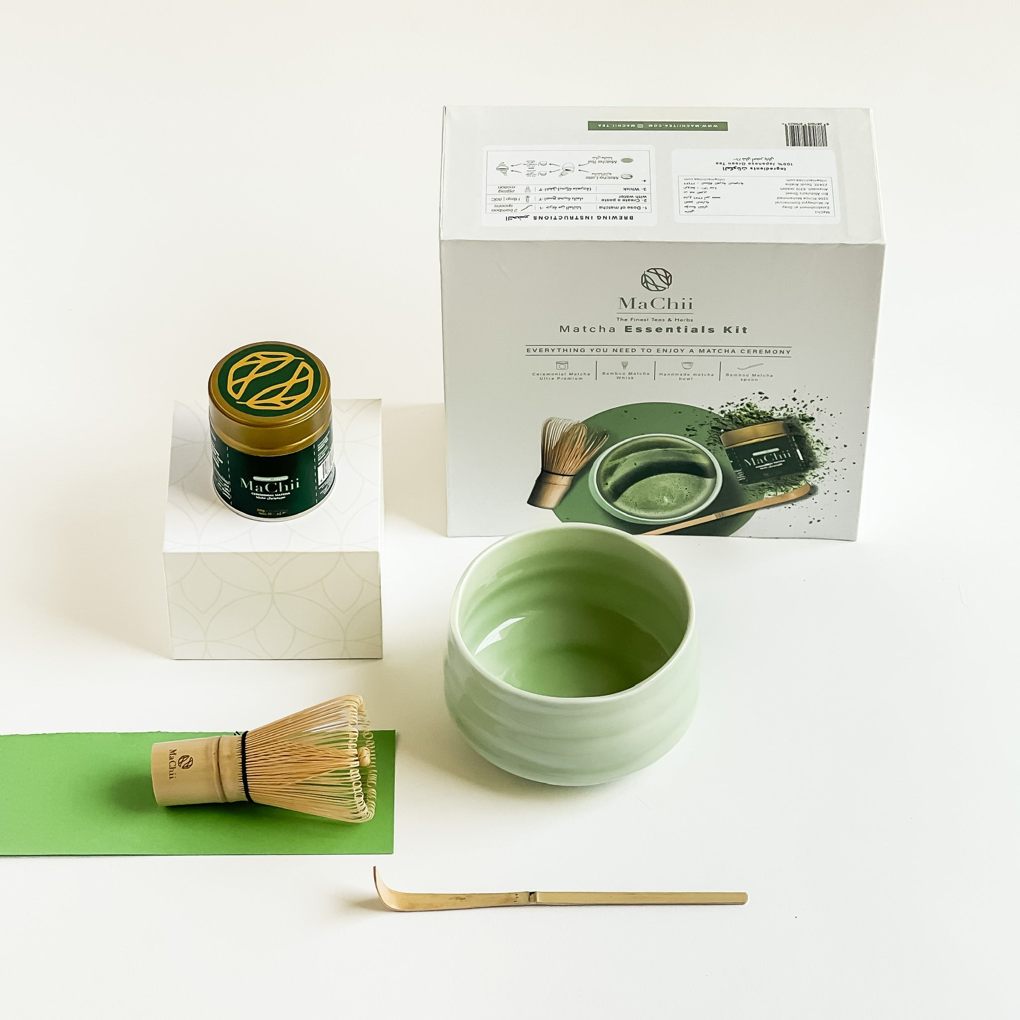 a matcha gift box with a gold 30g luxury organic matcha first harvest tin, a 120 pondat matcha whisk, a green matcha bowl and a bamboo scoop. the machii tea logo is engraved on every product,