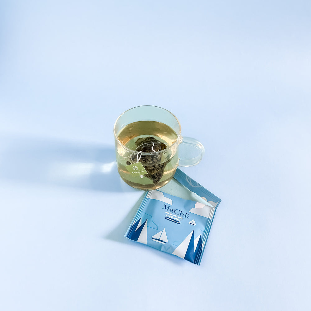 wholesale oolong tea brewing in a double-walled glass cup. 