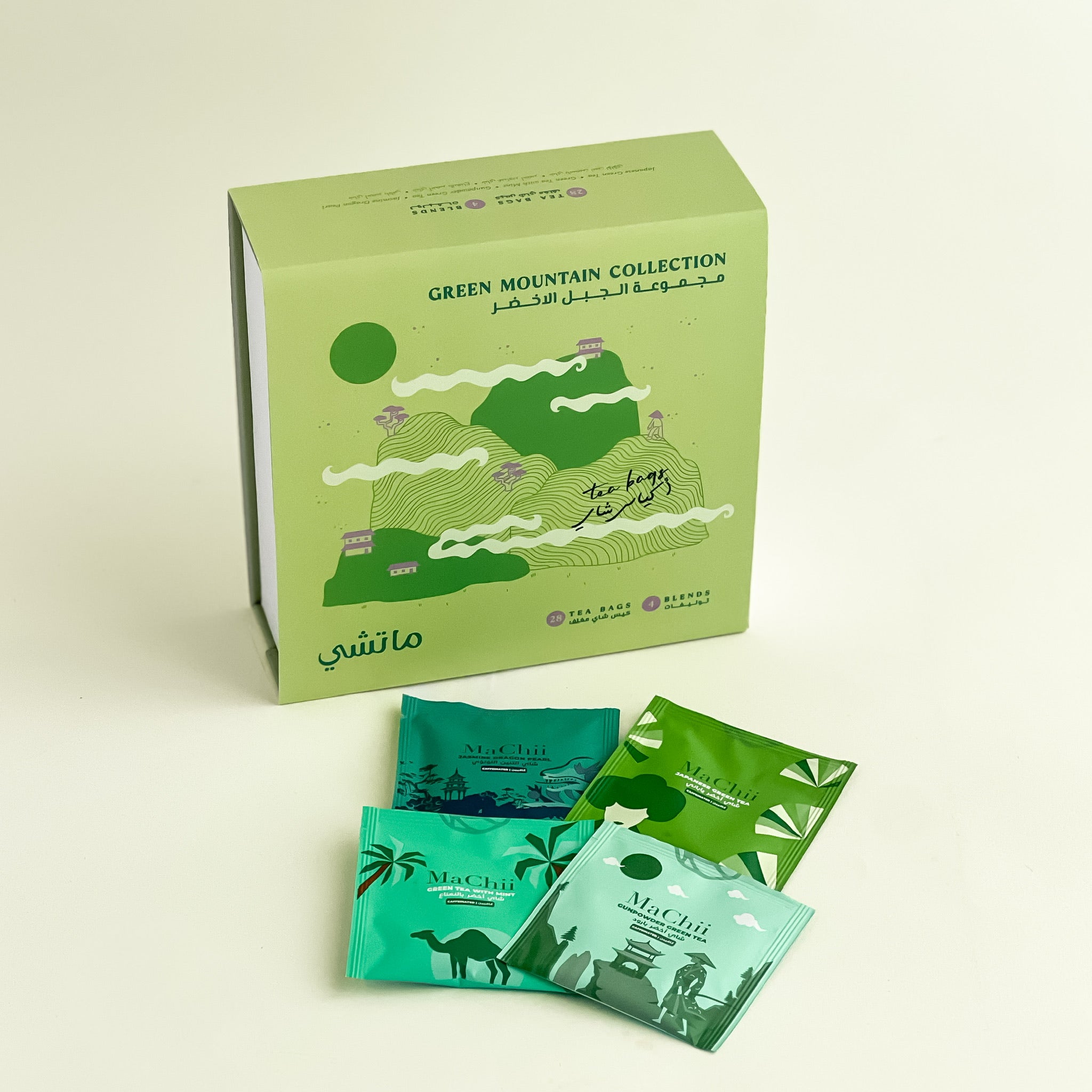 green tea box with four envelopes. gunpowder green tea, Japanese sencha green tea, green tea with Medina mint and jasmine dragon pearl tea. the gift box has a nice zen illustration and MaChii Tea logo 