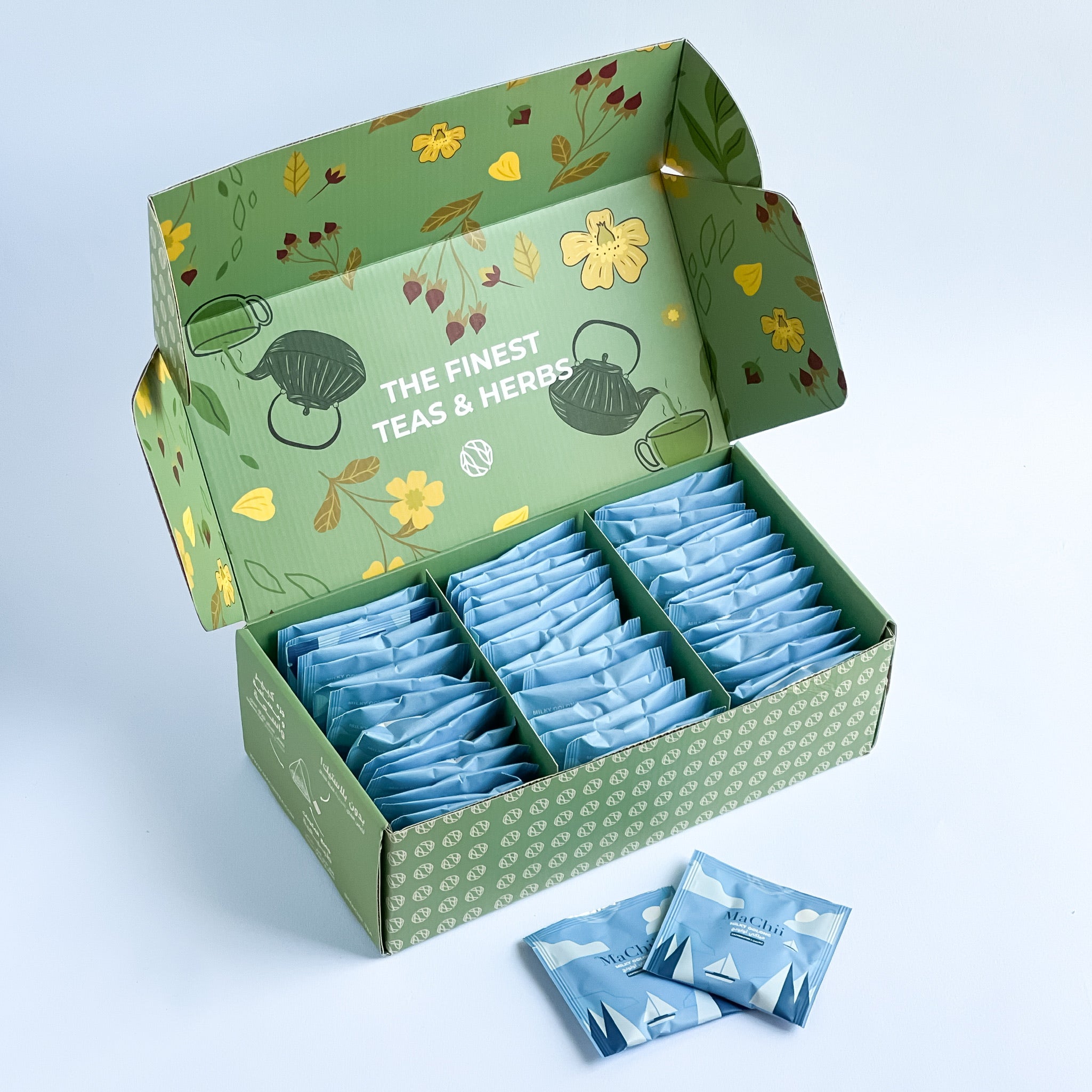 milky oolong tea in a wholesale MaChii Tea box. the box has 50 individually wrapped enveloped tea bags in rows of 3