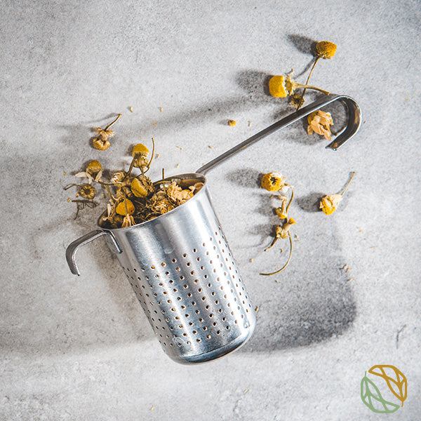 
                  
                    loose leaf chamomile flowers in a strainer
                  
                